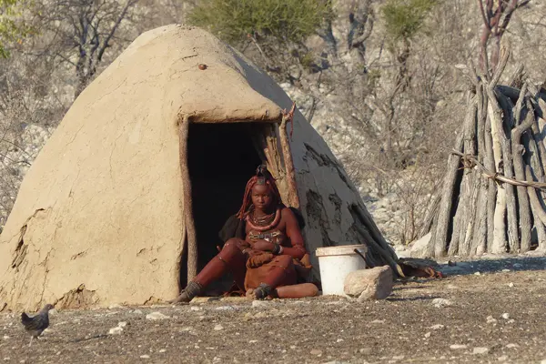 Himba woman outside her hut
